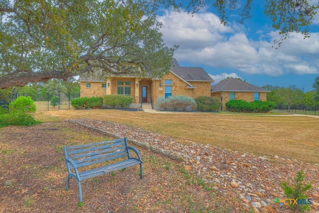 ranch-style home featuring a front lawn