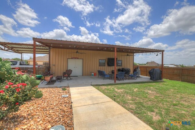 108 Westfield Vw, La Vernia, TX 78121 - back of property with board and batten siding, ceiling fan, and a patio area