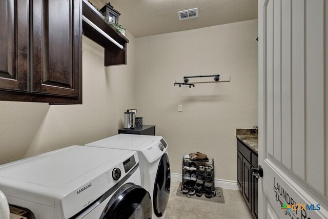 108 Westfield Vw, La Vernia, TX 78121 - laundry area with separate washer and dryer, cabinet space, and baseboards