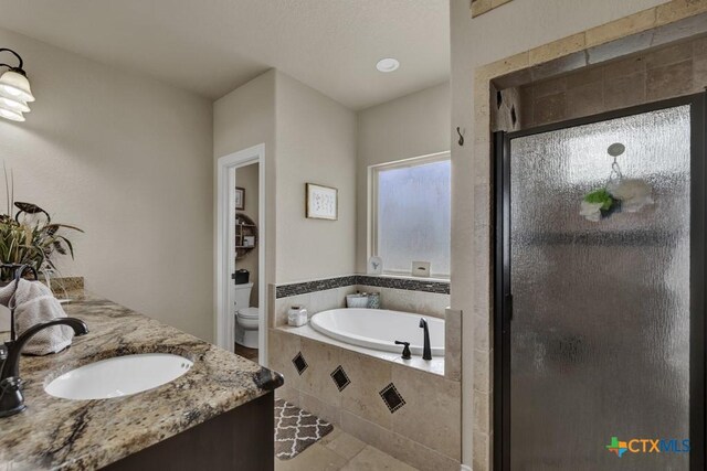 108 Westfield Vw, La Vernia, TX 78121 - full bathroom with toilet, a garden tub, a shower stall, double vanity, and tile patterned floors