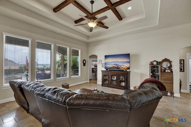 108 Westfield Vw, La Vernia, TX 78121 - living room with arched walkways, stone tile flooring, baseboards, a ceiling fan, and recessed lighting