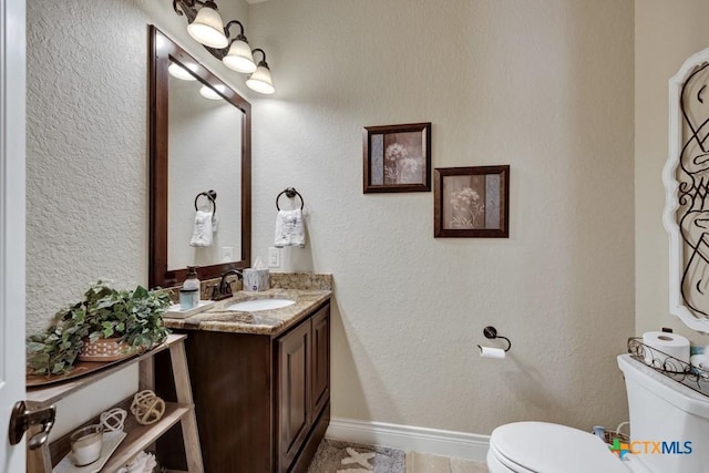108 Westfield Vw, La Vernia, TX 78121 - half bathroom featuring toilet, vanity, and baseboards