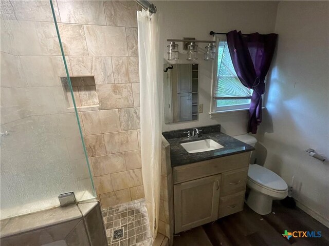 1505 E Park Ave, Victoria, TX 77901 - full bath featuring a stall shower, vanity, and wood finished floors