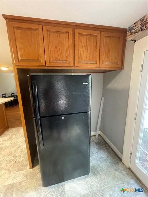 1505 E Park Ave, Victoria, TX 77901 - kitchen view of freestanding refrigerator and brown cabinetry