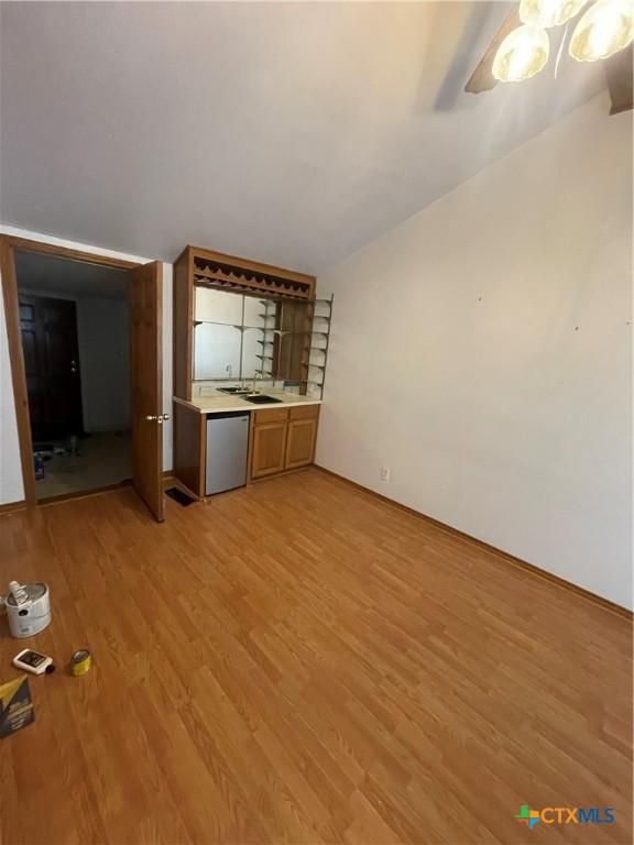 1505 E Park Ave, Victoria, TX 77901 - unfurnished living room with light wood-style flooring and a sink