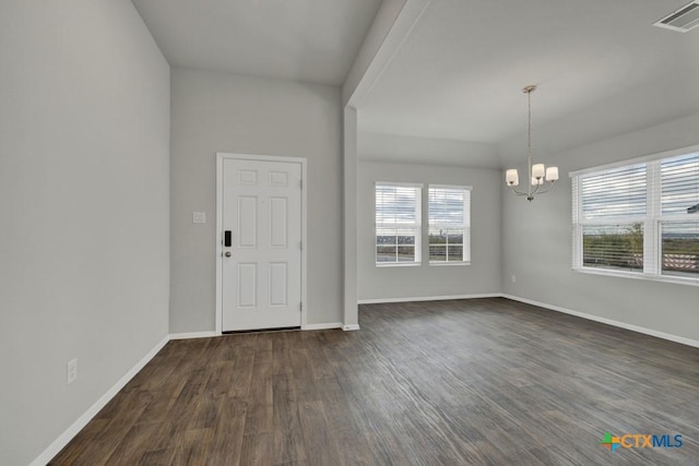 entrance foyer with dark wood-type flooring and a chandelier