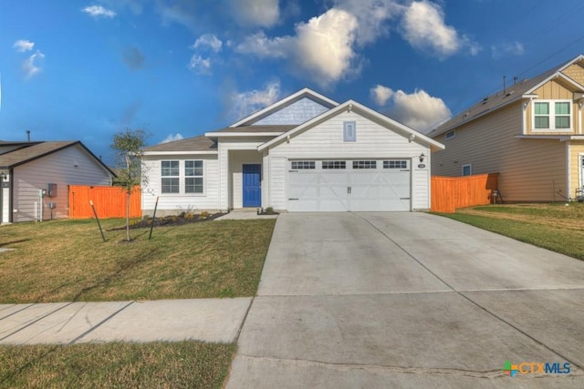 view of front of house with a garage and a front lawn