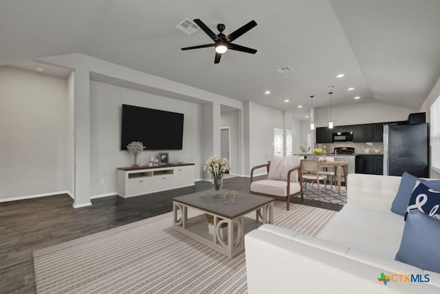 living room featuring dark wood-type flooring, vaulted ceiling, and ceiling fan