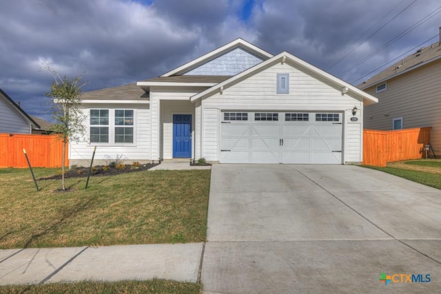 view of front of property featuring a garage and a front yard