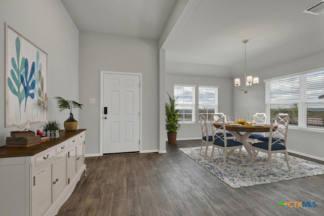 dining area with a chandelier and dark hardwood / wood-style flooring