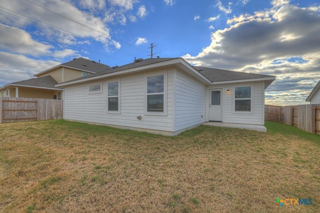 rear view of house with a yard