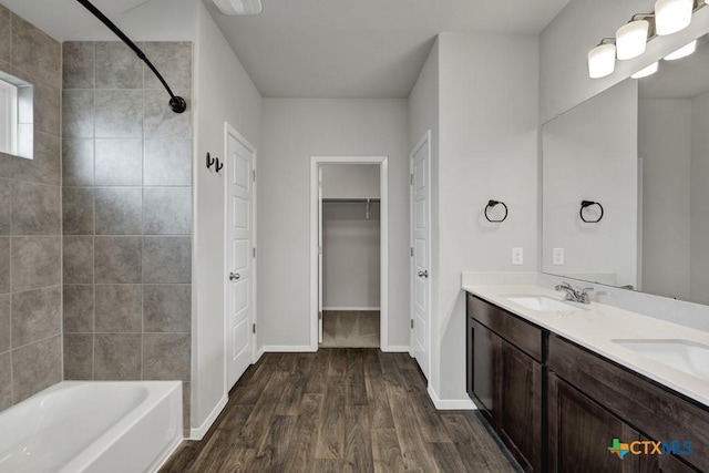 bathroom featuring tiled shower / bath, vanity, and hardwood / wood-style floors