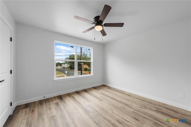 unfurnished bedroom with ceiling fan, baseboards, and wood finished floors