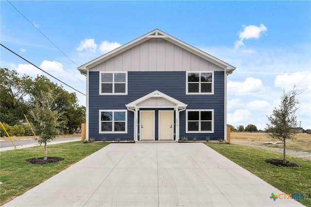 view of front of house featuring a front lawn and board and batten siding