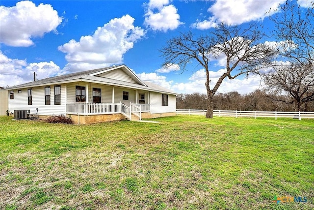 rear view of property featuring a porch, a yard, fence, and central AC unit