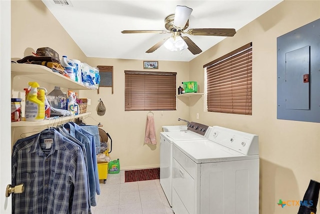 clothes washing area featuring washing machine and dryer, ceiling fan, laundry area, electric panel, and baseboards