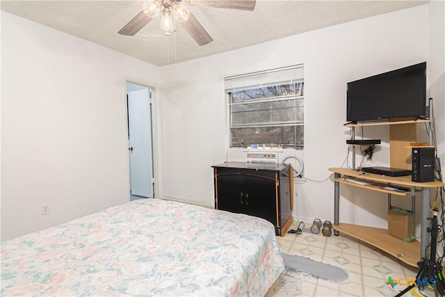 bedroom featuring a textured ceiling and ceiling fan