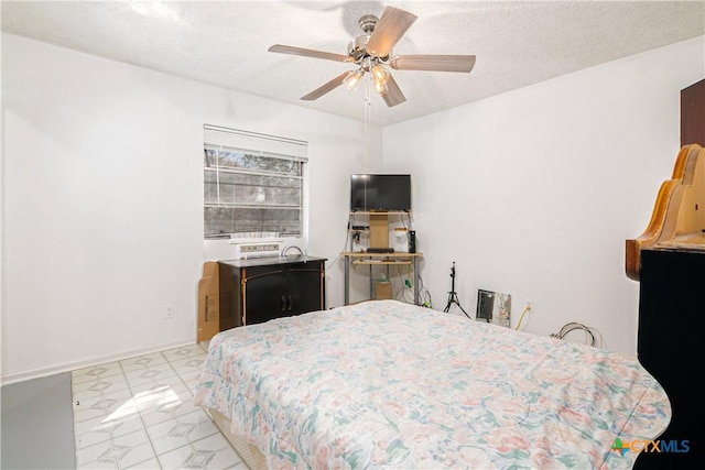 bedroom with a textured ceiling and ceiling fan