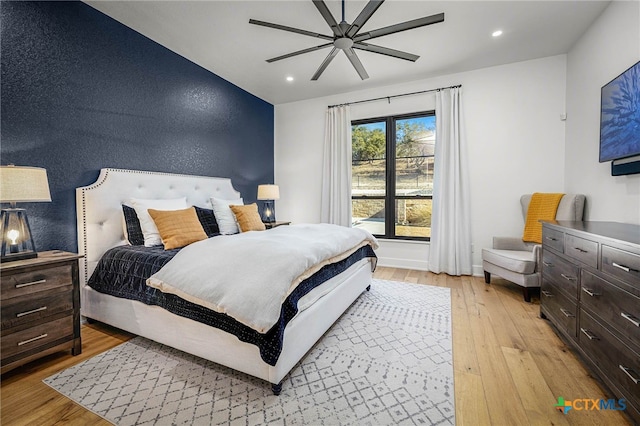 bedroom with ceiling fan and light hardwood / wood-style flooring