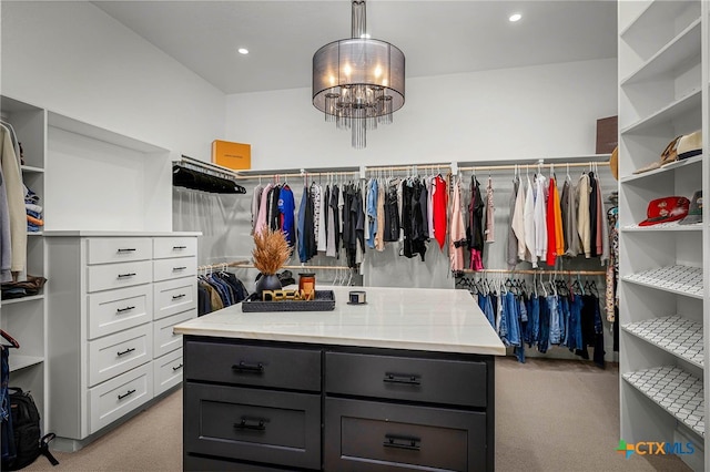 spacious closet with light carpet and a chandelier