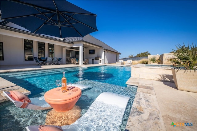 view of swimming pool with a patio area