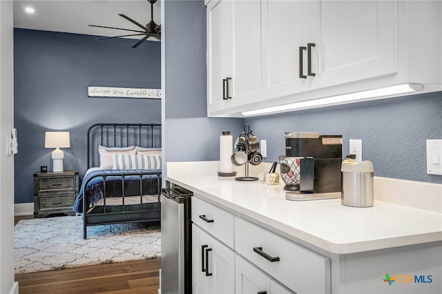 bedroom with wine cooler and dark wood-type flooring