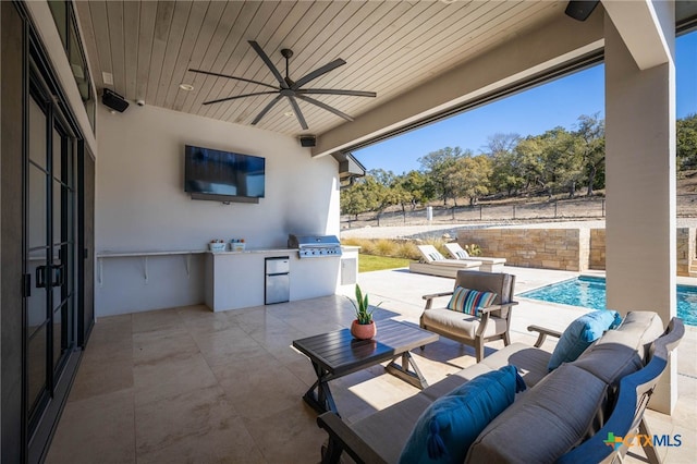 view of patio featuring area for grilling, an outdoor kitchen, an outdoor hangout area, and ceiling fan