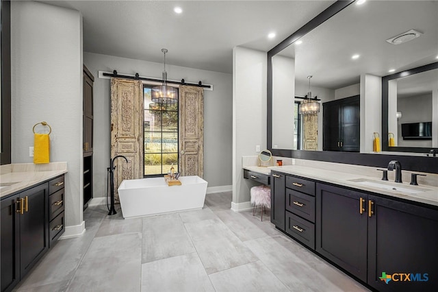 bathroom with vanity and a bath