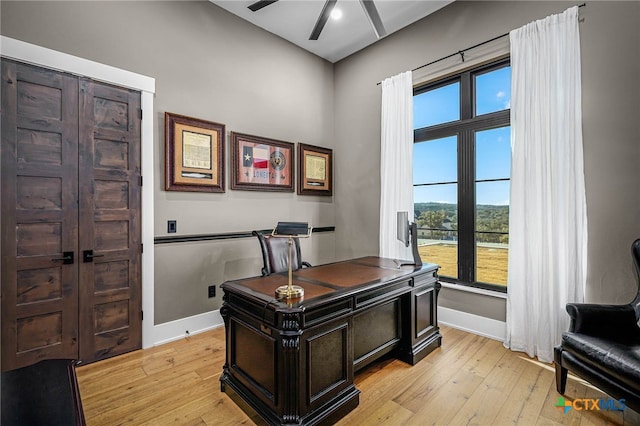 office space with ceiling fan and light hardwood / wood-style floors