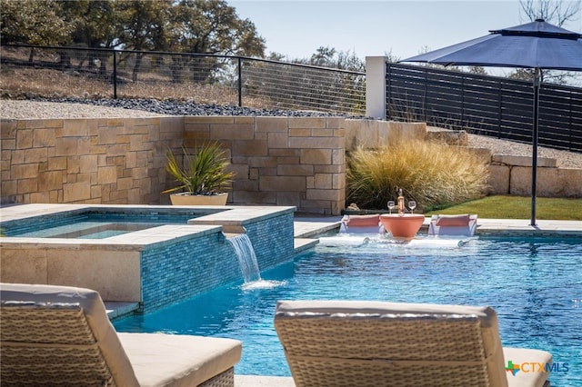 view of swimming pool with an in ground hot tub and pool water feature