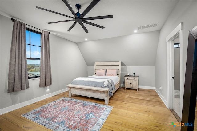 bedroom with ceiling fan, lofted ceiling, and light hardwood / wood-style floors