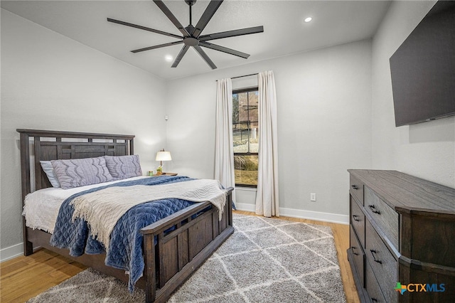 bedroom with ceiling fan and light hardwood / wood-style floors