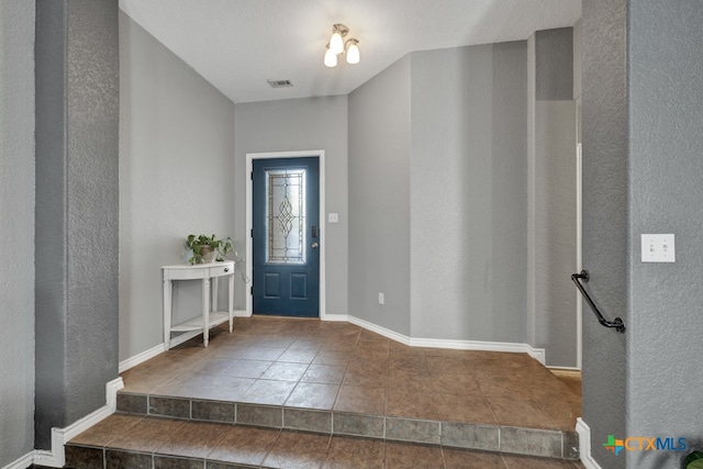 entrance foyer featuring tile patterned flooring and a textured ceiling