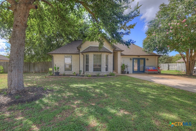 view of front of house with french doors and a front lawn