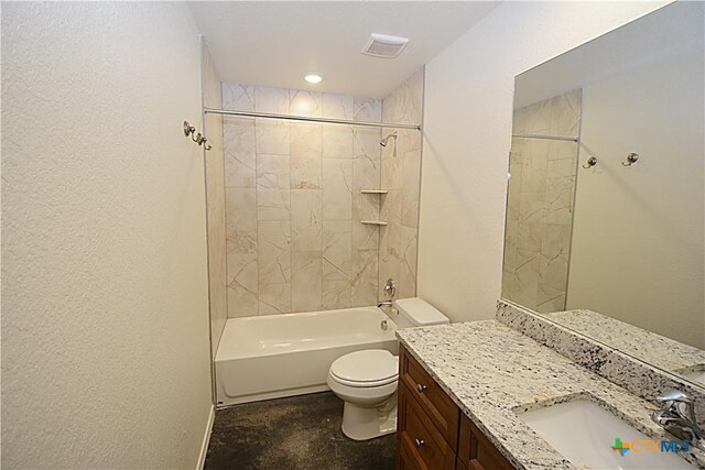 full bathroom featuring tiled shower / bath, vanity, and toilet