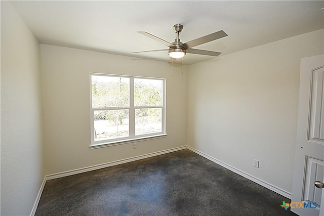 unfurnished room featuring ceiling fan and baseboards