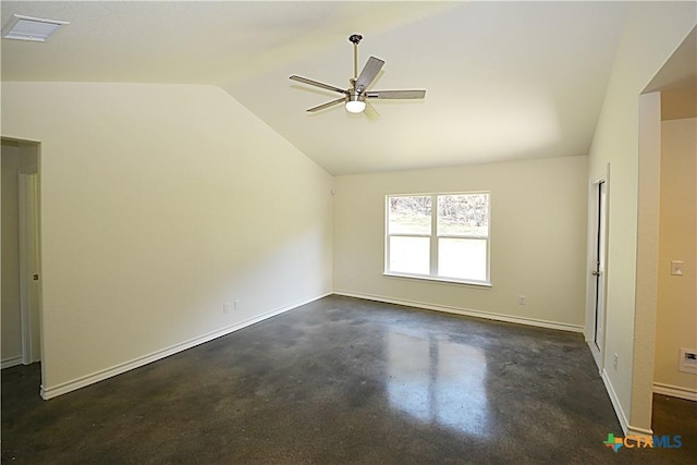 spare room with finished concrete flooring, visible vents, vaulted ceiling, ceiling fan, and baseboards