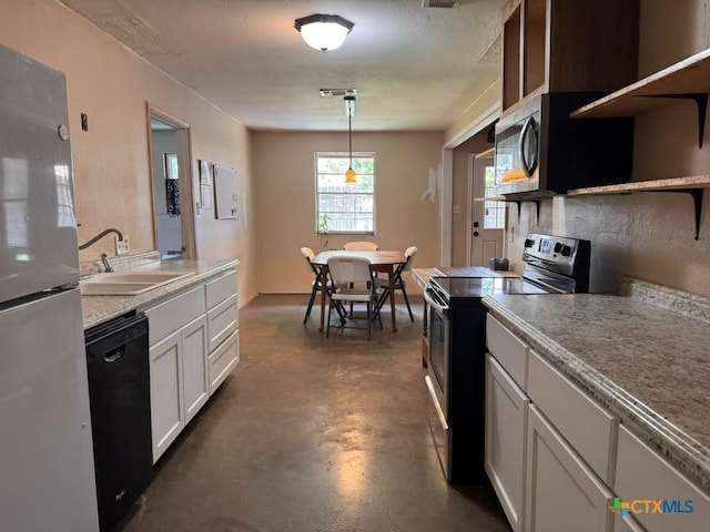 2708 E Poplar Ave, Victoria, TX 77901 - kitchen featuring electric range oven, open shelves, freestanding refrigerator, dishwasher, and a sink