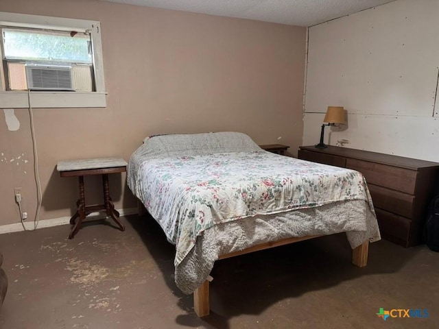 2708 E Poplar Ave, Victoria, TX 77901 - bedroom with cooling unit, concrete flooring, and baseboards