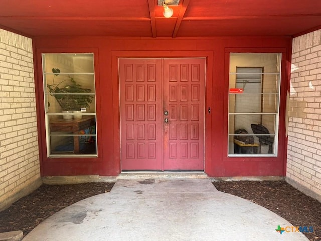 2708 E Poplar Ave, Victoria, TX 77901 - doorway to property featuring brick siding