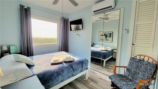 1265 N Ocean Dr Unit 2, Port Lavaca, TX 77979 - bedroom with wood finished floors, an AC wall unit, and a ceiling fan