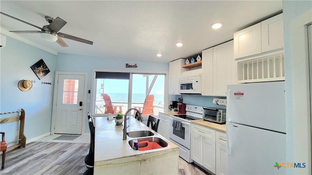 1265 N Ocean Dr Unit 2, Port Lavaca, TX 77979 - kitchen featuring open shelves, white appliances, a sink, and white cabinets