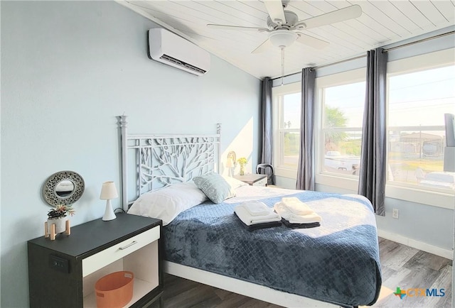 1265 N Ocean Dr Unit 2, Port Lavaca, TX 77979 - bedroom featuring baseboards, a ceiling fan, wood finished floors, and a wall unit AC