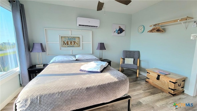 1265 N Ocean Dr Unit 2, Port Lavaca, TX 77979 - bedroom with baseboards, wood finished floors, and a wall mounted AC