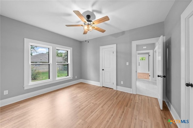 unfurnished bedroom with ceiling fan and light wood-type flooring