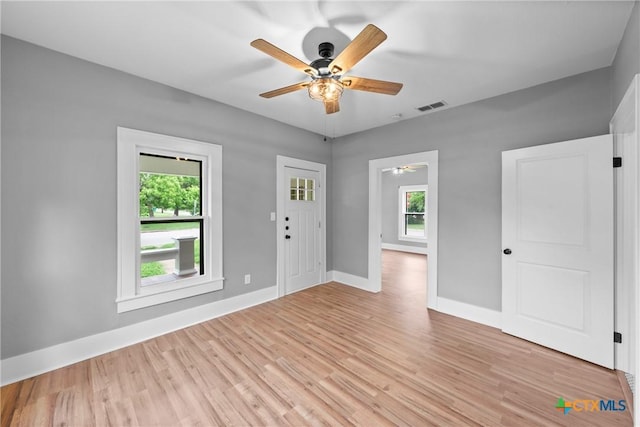 spare room featuring ceiling fan and light hardwood / wood-style floors