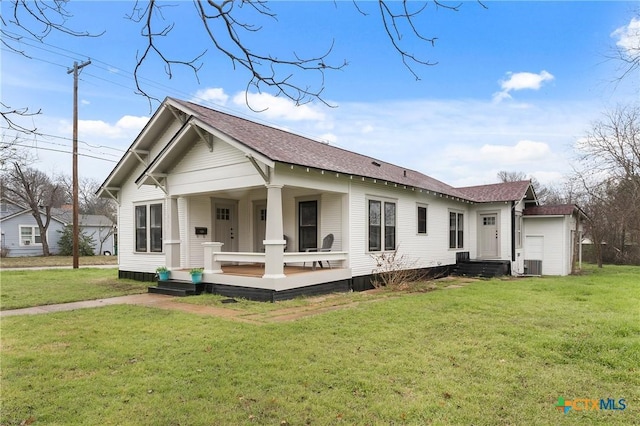 rear view of property featuring a yard and cooling unit