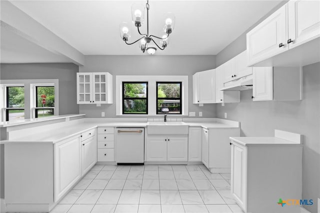 kitchen featuring white cabinetry, white dishwasher, and kitchen peninsula