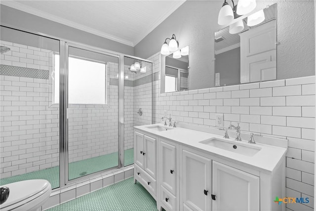 bathroom featuring toilet, a shower with shower door, tile walls, ornamental molding, and vanity