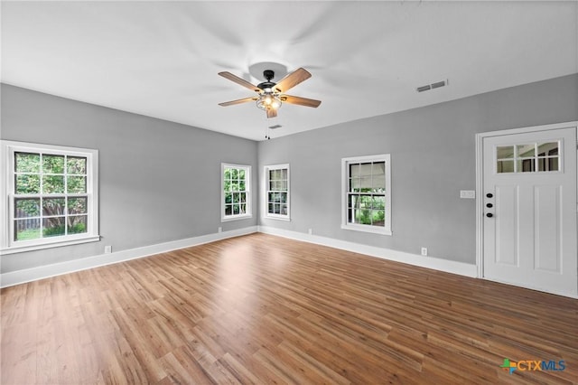 unfurnished living room with ceiling fan and light hardwood / wood-style floors